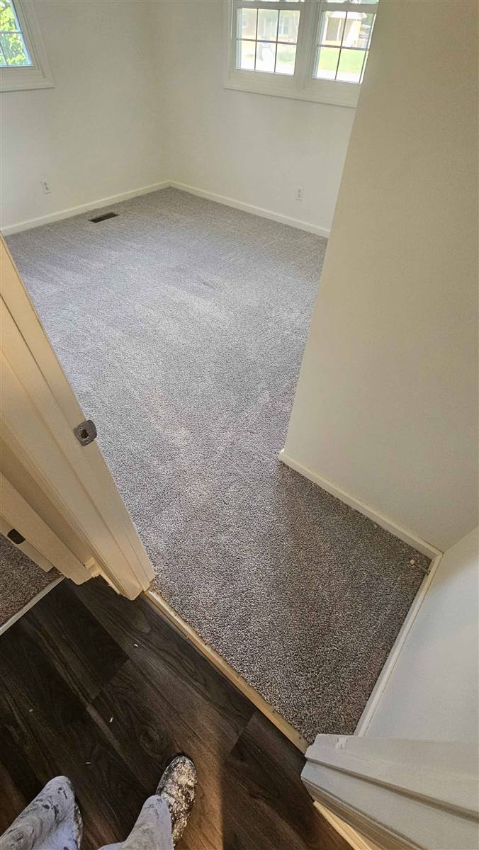 Bedroom after: fresh gray carpet neatly installed