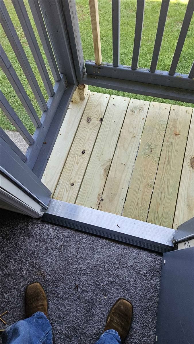 Balcony after: brand-new pressure-treated deck boards